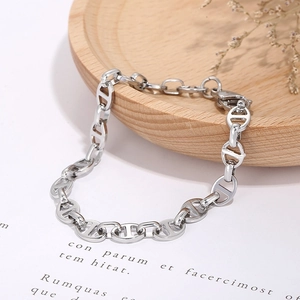 Minimalist silver stainless steel pig nose chain bracelet on a decorative wooden tray