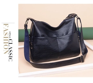 Detail of soft faux sheepskin crossbody bag with wide strap and zip pocket