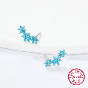 Detailed close-up of S925 sterling silver flower stud earrings with blue zircon stones