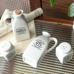 Minimalist white ceramic oil and vinegar dispenser set with cork stoppers and black labels