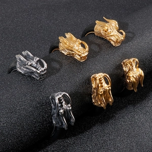 Gothic dragon head bangles in gold and silver finish displayed on a black textured roll