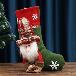 Christmas stocking gift bag with 3D Santa Claus figure on a festive wooden surface