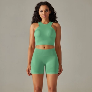 Detail of mint green seamless ribbed yoga set with halter crop top and high waist shorts