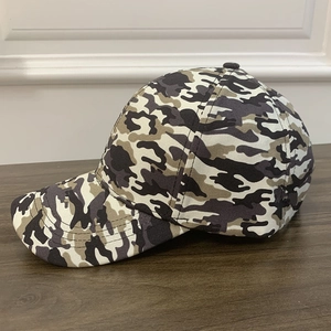 Classic tactical camouflage baseball cap with six-panel structure on a wooden surface