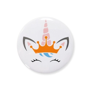Close-up of cute cartoon unicorn badge with crown and pink horn for birthday party