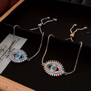 Detail showing vintage evil eye adjustable bracelets with colorful zircon in silver and gold