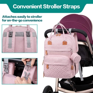 Detail of pink diaper bag showing stroller attachment hooks and ergonomic back structure