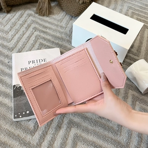 Short pink tri-fold leather wallet for women with card slots and bow detail
