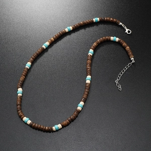 Detail of vintage boho necklace with turquoise beads and brown coconut wood discs