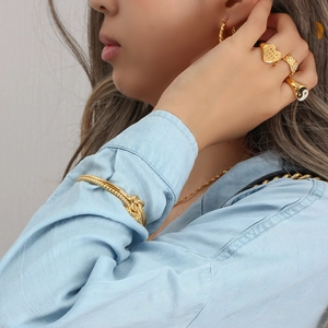 Golden knot cuff bracelet with heart ring and necklace set on model
