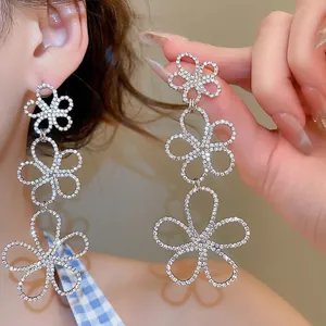 Elegant silver flower drop earrings with sparkling rhinestones and layered cutout design