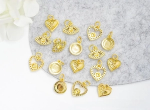 Detail of 18K gold plated DIY eye pendants with micro-inlaid zircon on grey felt