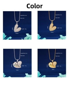 Detail view of gold and silver heart pendants with micro-pave zircons and snake chain