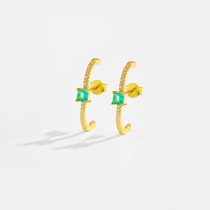 Detail showing S925 hallmark on gold plated earrings with green square gemstones