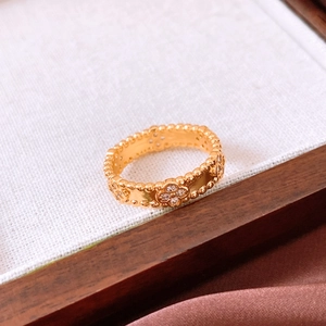 Detailed view of the gold flower ring featuring white zircon inlays and beaded edges