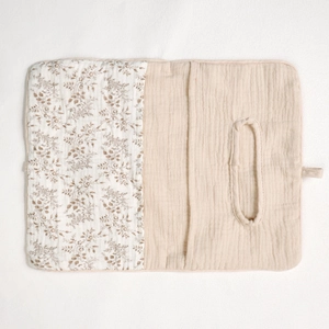 Detail of baby crib organizer showing soft cotton floral fabric and oval tissue opening