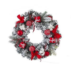 Christmas wreath with red bows, ornaments and cotton flowers on white background