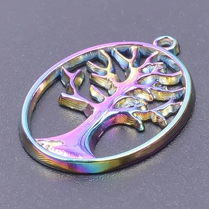Macro shot of an oval tree of life pendant with vibrant rainbow electroplating finish