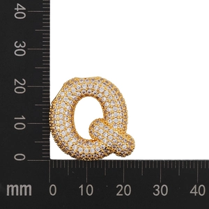 Detail showing letter Q zircon pendant measurements on ruler in millimeters