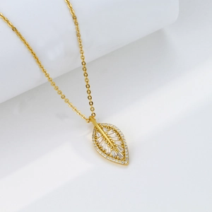 Macro shot of leaf pendant with baguette cut zircon and sparkling diamond edges