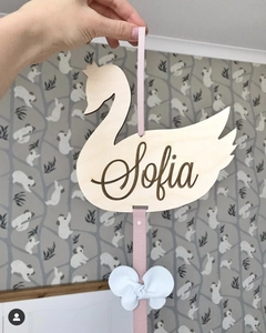 Custom wood swan hanging decor with pink ribbon and white bow featuring Sofia engraving