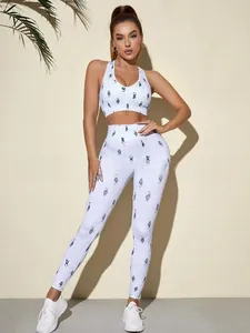 Detail of high-stretch yoga set with racerback bra and patterned leggings on model