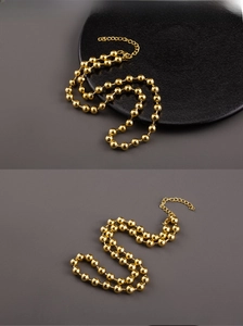 Detail of 18K gold-plated beaded chain necklace with lobster clasp and extender