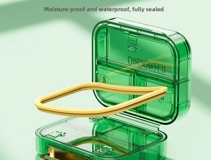 Detail of green pill organizer with silicone seal for waterproof and moisture-proof storage
