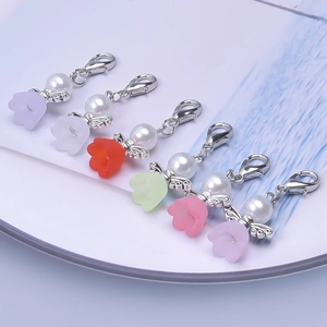 Detail view of colorful floral pendants with white pearls and silver lobster clasps