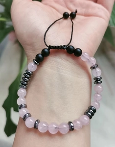 Close-up of You Are Loved Morse code bracelet with pink quartz and matte stones on wrist