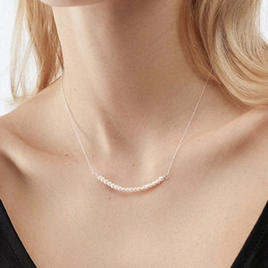 Minimalist freshwater pearl smile necklace on female model for an elegant daily look