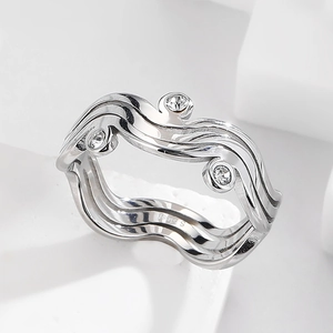Detailed macro view of silver layered wave ring with S.Steel engraving and zircon