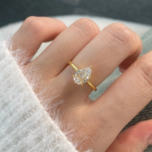 Detail of s925 sterling silver ring featuring a large pear-shaped champagne zircon gemstone
