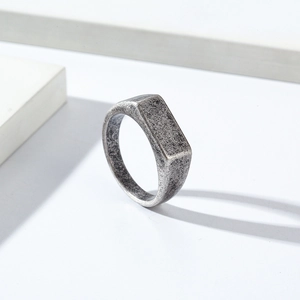 Macro detail of a vintage signet ring featuring a flat rectangular face and aged texture