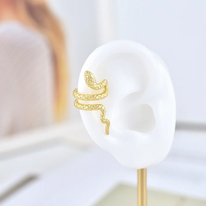 Detail of 18k gold plated snake ear cuff with textured scales on a white ear model