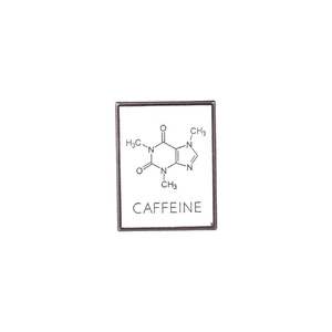Macro detail of white enamel caffeine chemical formula brooch with black outline
