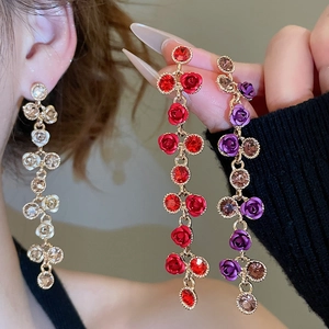 Detail of elegant rose floral tassel earrings with sparkling crystals and silver needles