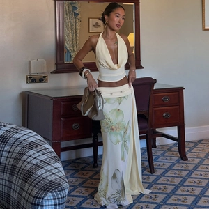 Detail view of floral print maxi skirt and halter neck top set for women in beige