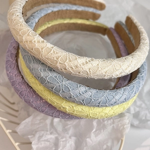 Close-up of four lace floral headbands showing intricate hollow patterns and texture