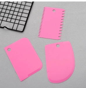 Three-piece set of pink plastic dough scrapers with straight and serrated edges for baking