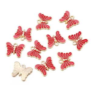 Detailed view of ten red enamel butterfly pendants with gold alloy plating for DIY jewelry