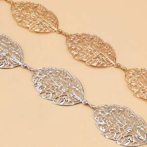 Close-up of elegant hollow leaf chain belts in polished gold and silver finishes