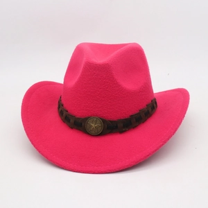 Detail of rose pink wool felt cowboy hat with vintage metal star emblem and brown band