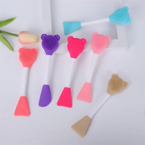 Dual-ended silicone facial cleanser brushes in various colors with bear-shaped heads