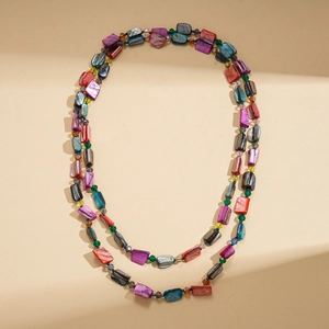 Macro view of colorful shell beads and crystal spacers on long Bohemian necklace