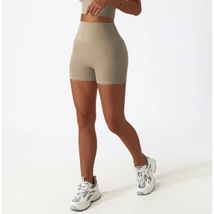 Detail view of khaki high-waisted yoga shorts with side pockets and breathable fabric