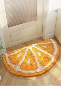 Close-up of soft tufted orange slice bathroom mat with high water absorption