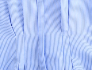 Close-up of blue and white striped cotton fabric texture with natural soft folds