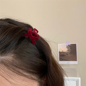 Mini burgundy velvet bow hair claw clip styled on dark hair for side accent