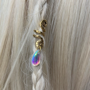 Golden spiral hair jewelry with a rainbow teardrop charm on light blonde braided hair